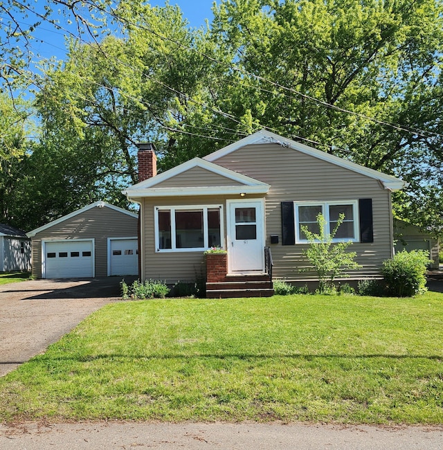 51 Francis St, Waterville, ME 04901 - bungalow-style house featuring entry steps, a chimney, an outbuilding, a garage, and a front lawn