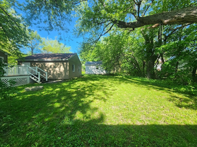 51 Francis St, Waterville, ME 04901 - view of grassy yard featuring a deck and an outdoor structure
