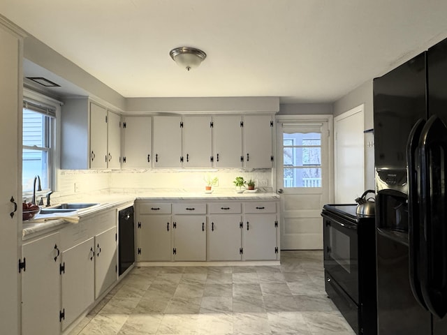 51 Francis St, Waterville, ME 04901 - kitchen with black appliances, light countertops, a sink, and decorative backsplash