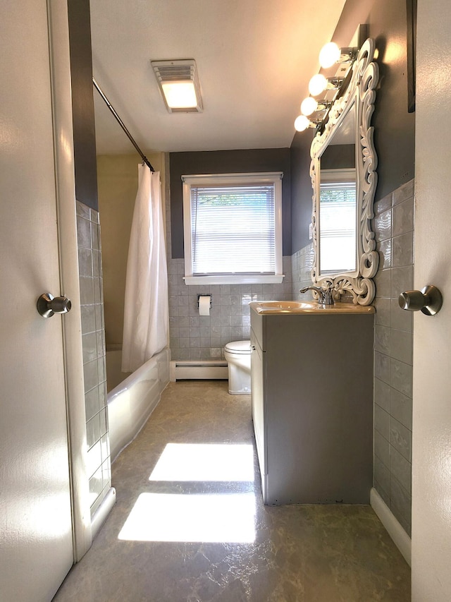 51 Francis St, Waterville, ME 04901 - full bathroom with a baseboard heating unit, tile walls, vanity, toilet, and shower / tub combo