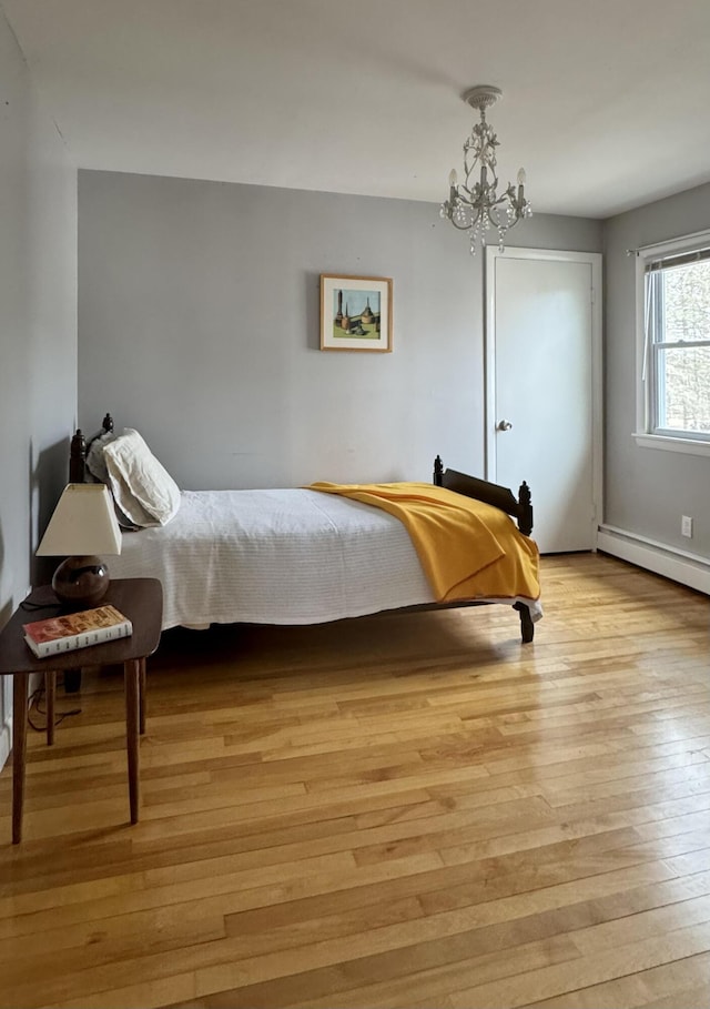 51 Francis St, Waterville, ME 04901 - bedroom featuring light wood-type flooring, a chandelier, and baseboard heating