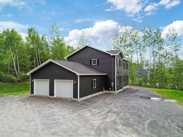 65 May Way, Sidney, ME 04330 - view of property exterior with a garage and roof with shingles