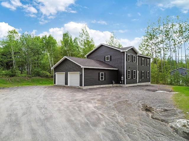 65 May Way, Sidney, ME 04330 - view of property exterior with an attached garage and driveway
