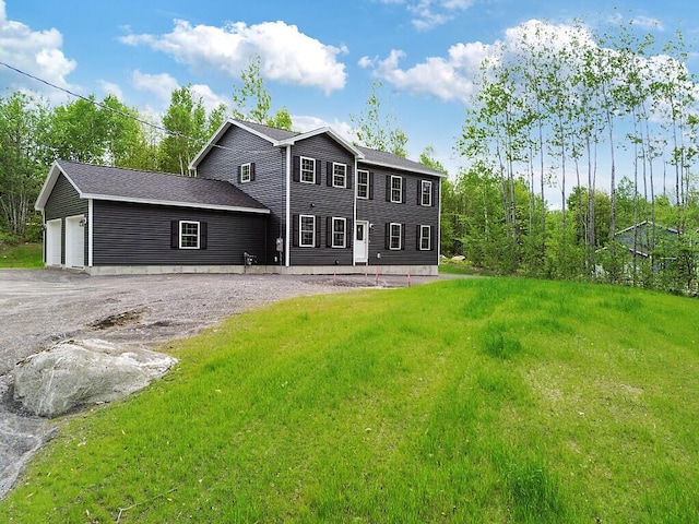 65 May Way, Sidney, ME 04330 - colonial home featuring a front lawn and asphalt driveway