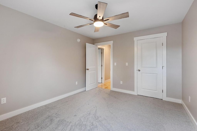 65 May Way, Sidney, ME 04330 - unfurnished bedroom featuring light colored carpet, baseboards, and a ceiling fan
