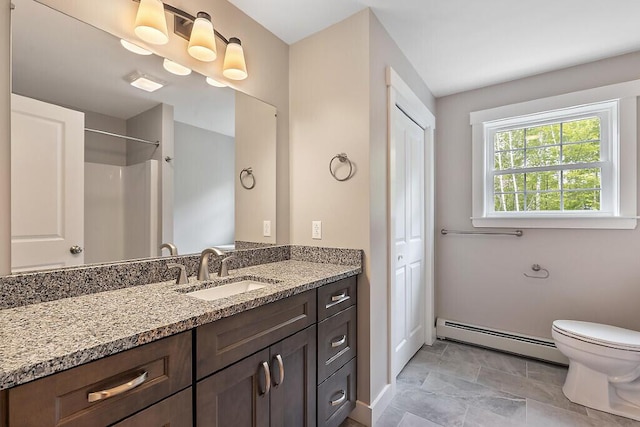 65 May Way, Sidney, ME 04330 - bathroom featuring a baseboard radiator, vanity, toilet, a shower, and baseboards