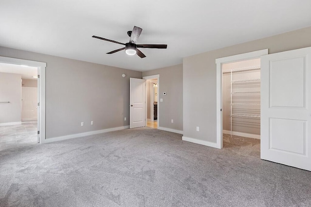 65 May Way, Sidney, ME 04330 - unfurnished bedroom with a walk in closet, carpet floors, and baseboards