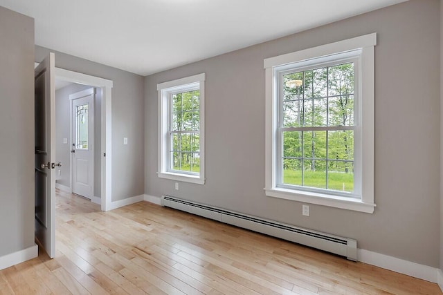 65 May Way, Sidney, ME 04330 - empty room featuring baseboard heating, baseboards, and light wood-style floors