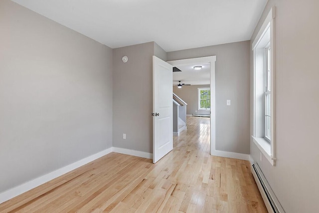 65 May Way, Sidney, ME 04330 - empty room featuring a baseboard heating unit, a ceiling fan, light wood-style floors, and baseboards