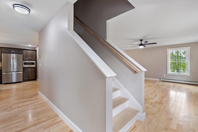 65 May Way, Sidney, ME 04330 - stairway with a baseboard heating unit, wood finished floors, baseboards, and ceiling fan