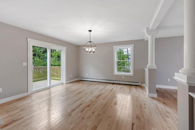 65 May Way, Sidney, ME 04330 - empty room featuring a baseboard heating unit, ornate columns, light wood-style floors, and baseboards