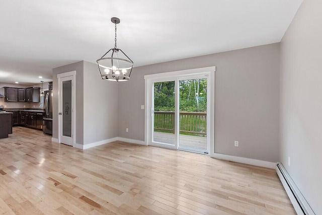 65 May Way, Sidney, ME 04330 - unfurnished room featuring baseboard heating, a chandelier, light wood-style floors, baseboards, and recessed lighting