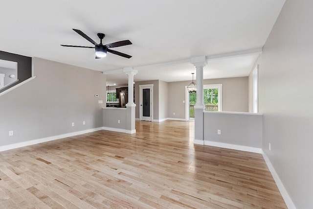 65 May Way, Sidney, ME 04330 - unfurnished living room with ornate columns, light wood-type flooring, a ceiling fan, and baseboards