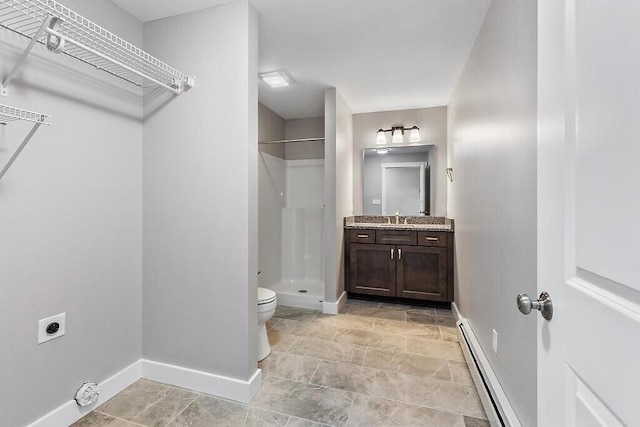 65 May Way, Sidney, ME 04330 - bathroom featuring a baseboard heating unit, baseboards, a shower stall, vanity, and toilet