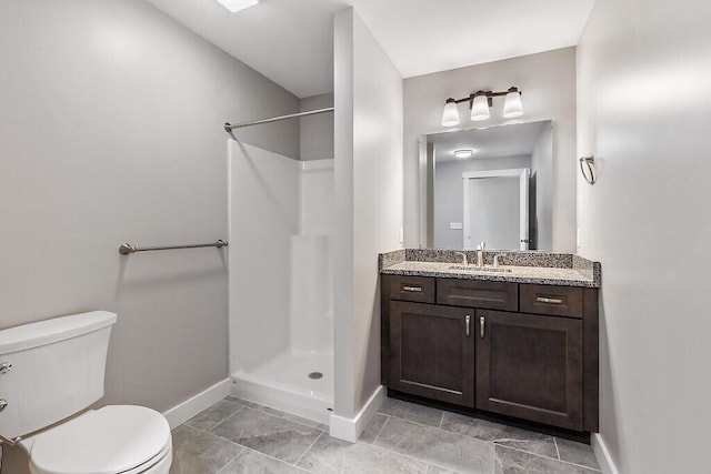 65 May Way, Sidney, ME 04330 - bathroom with baseboards, toilet, a shower, and vanity