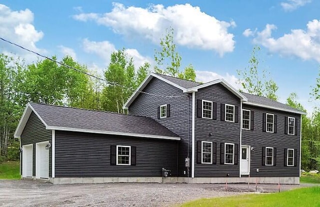65 May Way, Sidney, ME 04330 - view of front of home with asphalt driveway and a garage