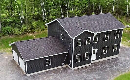 65 May Way, Sidney, ME 04330 - view of front facade with a forest view and roof with shingles