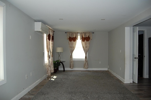 30 Westland Ave, Biddeford, ME 04005 - spare room with wood finished floors, baseboards, and a wall mounted AC