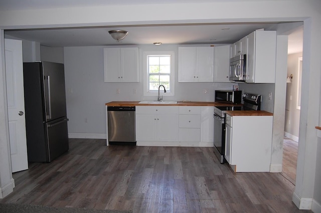 30 Westland Ave, Biddeford, ME 04005 - kitchen featuring stainless steel appliances, a sink, butcher block countertops, and dark wood-type flooring