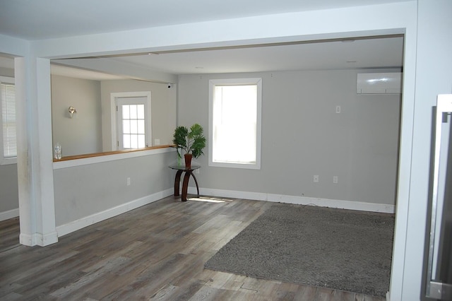 30 Westland Ave, Biddeford, ME 04005 - empty room featuring a wall unit AC, wood finished floors, and baseboards