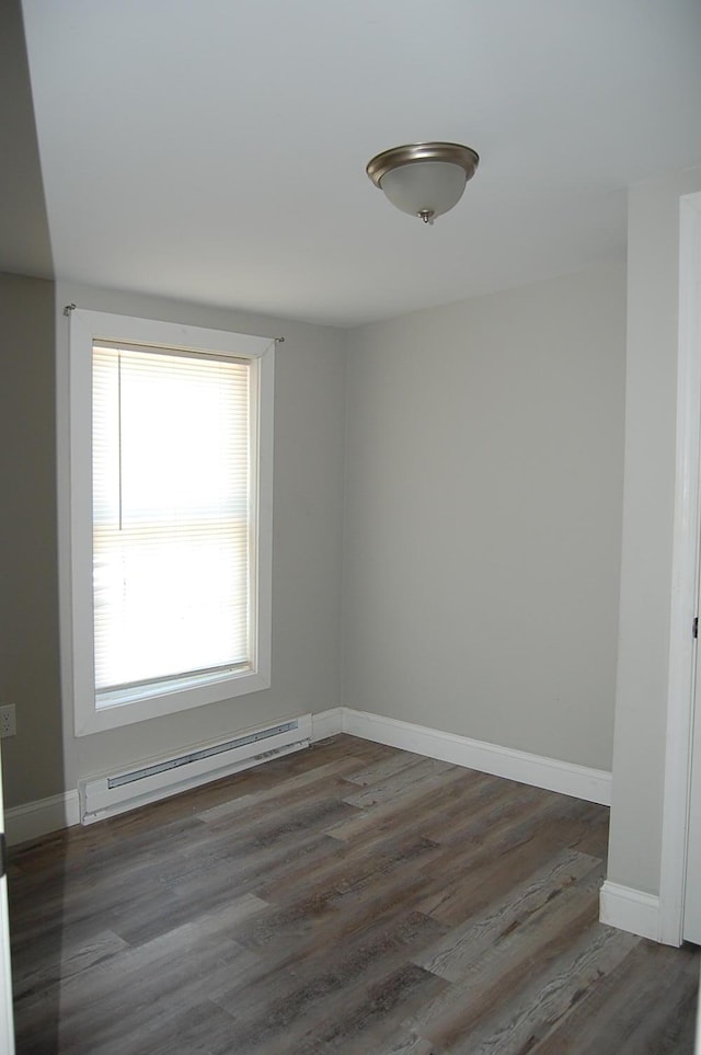 30 Westland Ave, Biddeford, ME 04005 - empty room featuring baseboard heating, wood finished floors, and baseboards