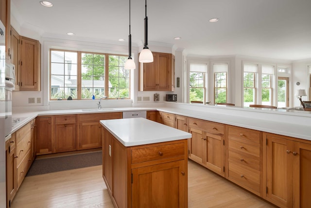 22 Saints Pl, Wells, ME 04090 - kitchen with healthy amount of natural light, light countertops, recessed lighting, light wood-style floors, and crown molding