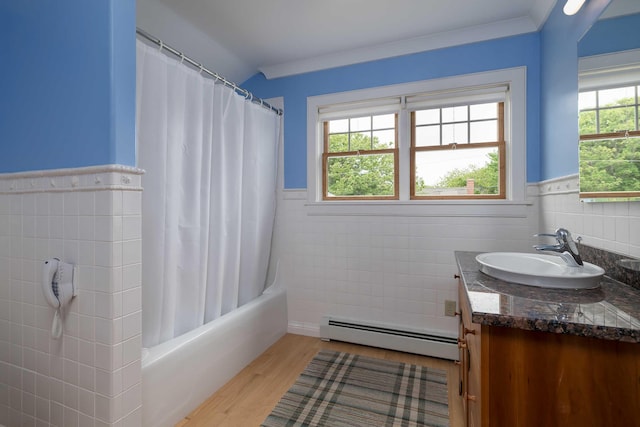 22 Saints Pl, Wells, ME 04090 - full bath featuring a baseboard heating unit, tile walls, vanity, wood finished floors, and shower / tub combo with curtain