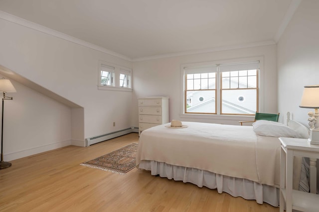 22 Saints Pl, Wells, ME 04090 - bedroom with a baseboard heating unit, wood finished floors, and ornamental molding
