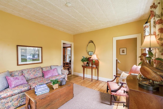 93 Elm St, Camden, ME 04843 - living area with hardwood / wood-style floors, baseboards, and an ornate ceiling