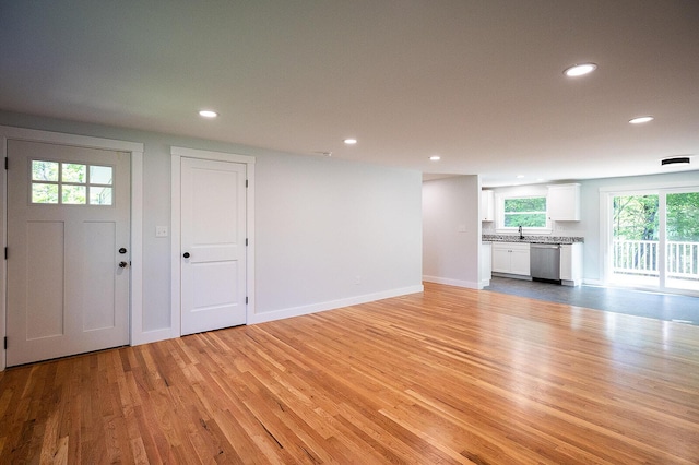 74 Hebron Rd, Paris, ME 04281 - unfurnished living room with light wood-style flooring, recessed lighting, baseboards, and a sink