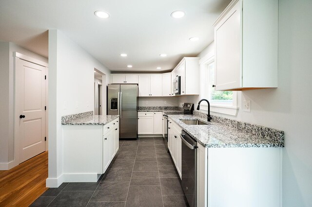 74 Hebron Rd, Paris, ME 04281 - kitchen with appliances with stainless steel finishes, a sink, white cabinetry, light stone counters, and recessed lighting