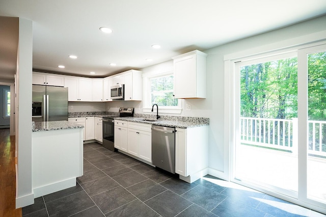 74 Hebron Rd, Paris, ME 04281 - kitchen with appliances with stainless steel finishes, a sink, light stone counters, white cabinets, and recessed lighting