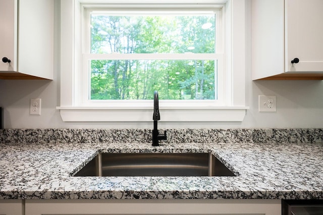 74 Hebron Rd, Paris, ME 04281 - kitchen view of a sink, white cabinetry, and light stone countertops
