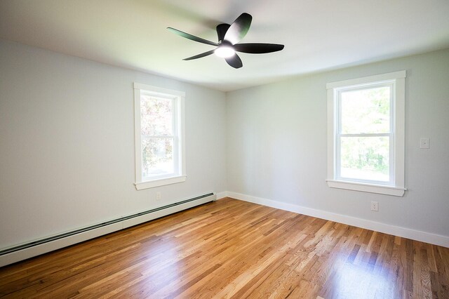 74 Hebron Rd, Paris, ME 04281 - empty room featuring a baseboard heating unit, light wood finished floors, baseboards, and ceiling fan