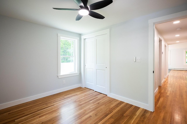 74 Hebron Rd, Paris, ME 04281 - unfurnished bedroom featuring light wood-style floors, baseboards, a closet, a baseboard heating unit, and ceiling fan