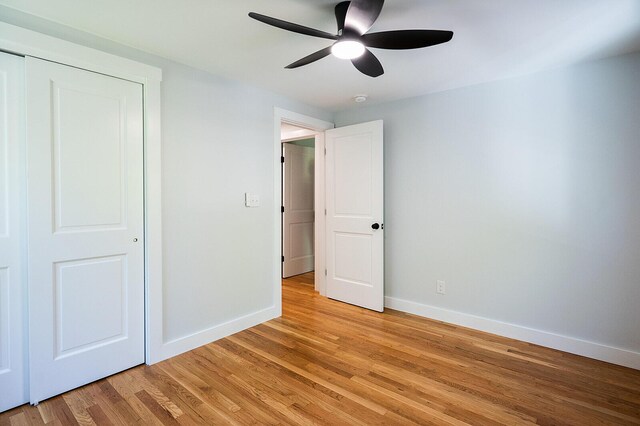 74 Hebron Rd, Paris, ME 04281 - unfurnished bedroom with baseboards, light wood-style flooring, a ceiling fan, and a closet