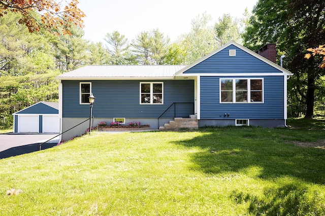 74 Hebron Rd, Paris, ME 04281 - view of front of house featuring an outdoor structure, a garage, metal roof, a front lawn, and a chimney