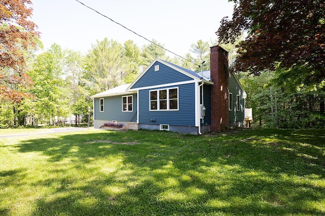 74 Hebron Rd, Paris, ME 04281 - back of property with a chimney and a yard