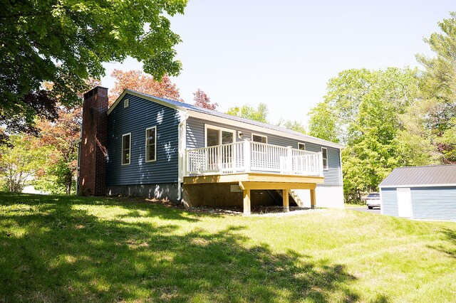 74 Hebron Rd, Paris, ME 04281 - view of front of house with a deck, a front lawn, a chimney, and an outbuilding