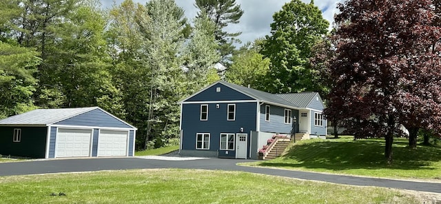 74 Hebron Rd, Paris, ME 04281 - view of front of property with a detached garage, an outdoor structure, a front yard, and view of scattered trees