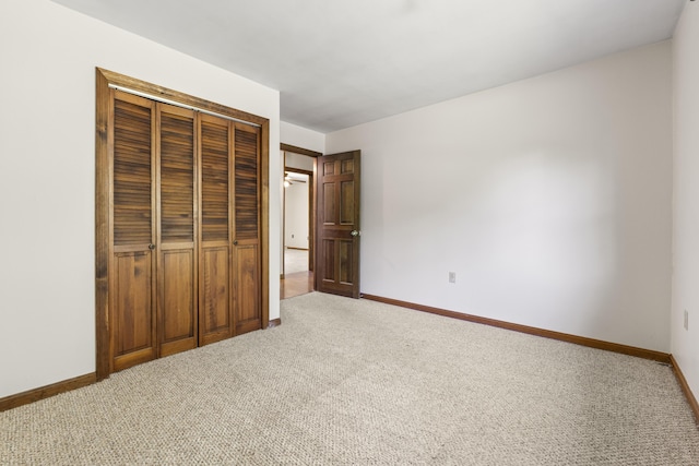 117 Taylor Woods Rd, Belgrade, ME 04917 - unfurnished bedroom featuring light colored carpet, baseboards, and a closet
