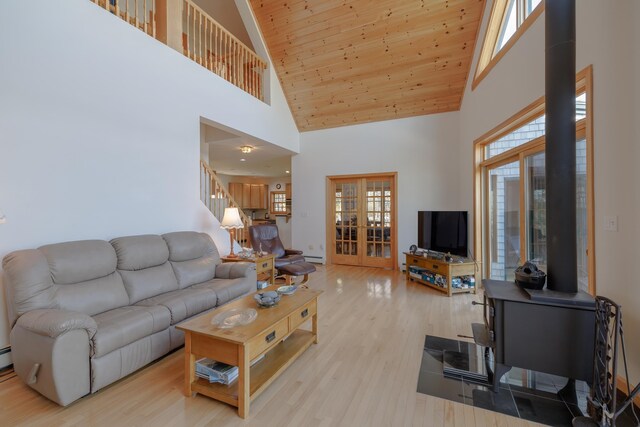 438 Oak Point Rd, Trenton, ME 04605 - living area featuring high vaulted ceiling, french doors, light wood-style floors, plenty of natural light, and wood ceiling