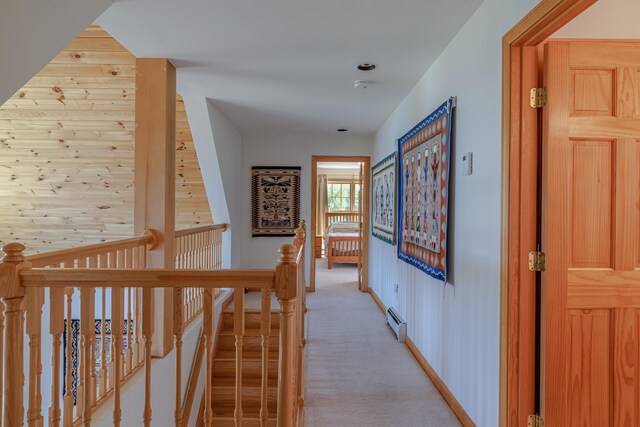 438 Oak Point Rd, Trenton, ME 04605 - hallway with an upstairs landing, a baseboard heating unit, light colored carpet, and baseboards