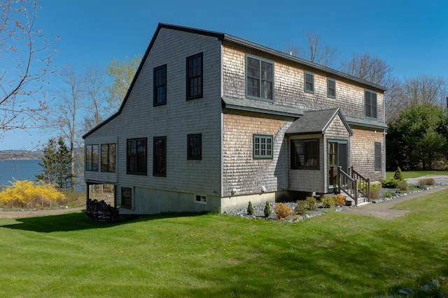 438 Oak Point Rd, Trenton, ME 04605 - back of property with entry steps, a lawn, and roof with shingles