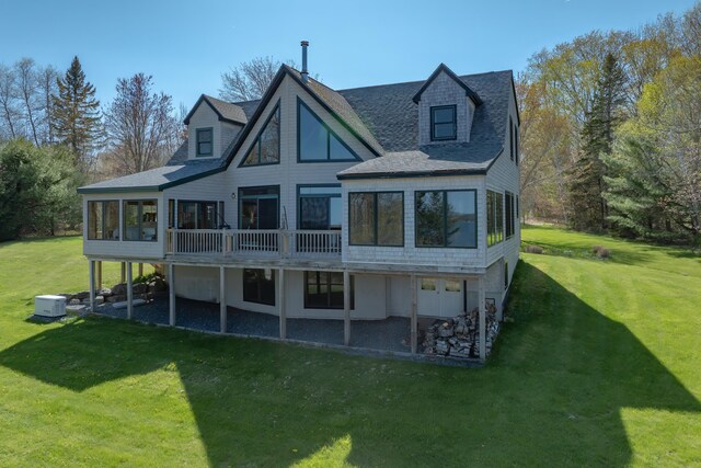 438 Oak Point Rd, Trenton, ME 04605 - rear view of property featuring a sunroom, a lawn, and roof with shingles