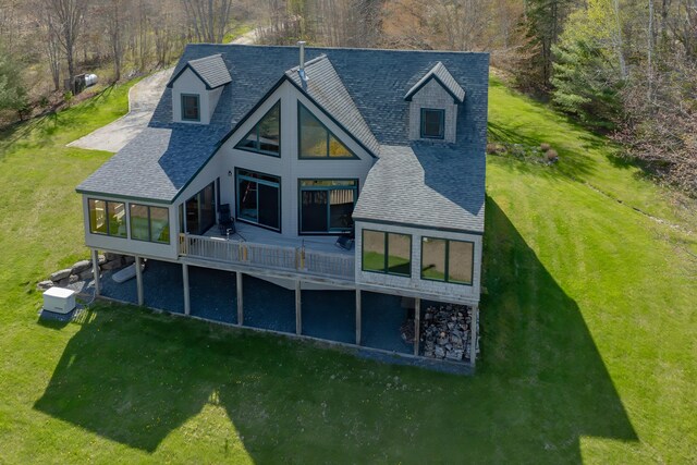 438 Oak Point Rd, Trenton, ME 04605 - back of house with a sunroom, a shingled roof, and a yard