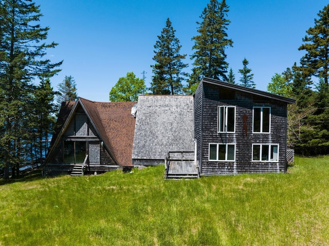 219 Willis Ln, Islesboro, ME 04848 - back of property featuring roof with shingles and a lawn