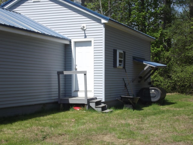 396 Waterville Rd, Norridgewock, ME 04957 - view of home's exterior with metal roof and a lawn