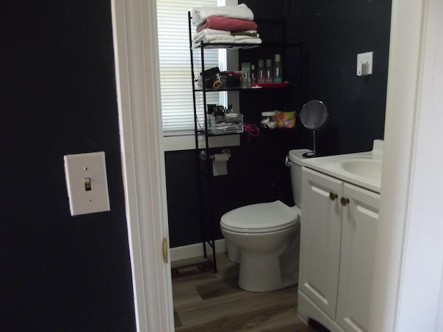 396 Waterville Rd, Norridgewock, ME 04957 - half bath with vanity, toilet, and wood finished floors