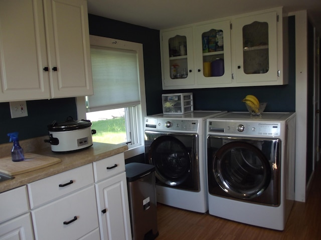 396 Waterville Rd, Norridgewock, ME 04957 - laundry room featuring washing machine and dryer, cabinet space, and dark wood finished floors